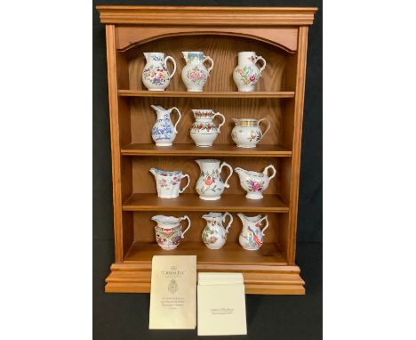 A set of twelve Royal Worcester 'Historic Jugs', commissioned by Compton &amp; Woodhouse, each with certificate, accompanying