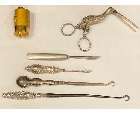 A pair of Victorian 'stork' ribbon threaders; silver hafted button hooks and manicure tools (6) 