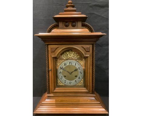 A late 19th/early 20th century oak bracket clock, brass dial with silvered chapter ring, Arabic numerals, twin winding holes,