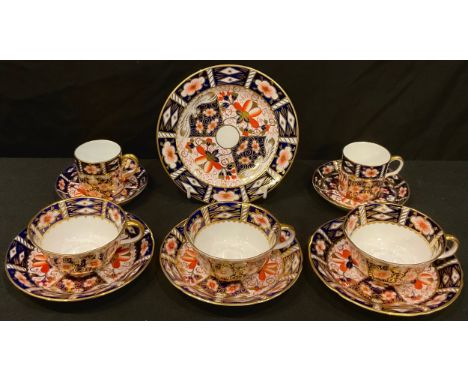 A Royal Crown Derby Imari palette 2451 pattern tea cup, saucer and tea plate, two teacups and saucers, two coffee cans and sa