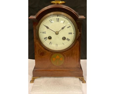 A late 19th/early 20th century mahogany inlaid mantel clock, arched case with brass carry handle, white enamel dial, Roman nu