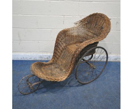 A VICTORIAN WICKER TRICICLE WHEELCHAIR (condition report: wicker damaged, woodworm)