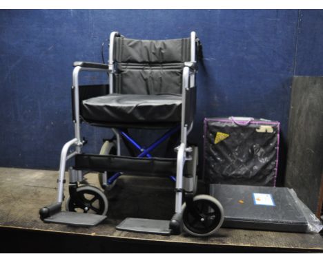 AN EXCEL GLOBETRAVELLER LIGHTWEIGHT FOLDING WHEELCHAIR with two footrests and three seat cushions along with a metal office d