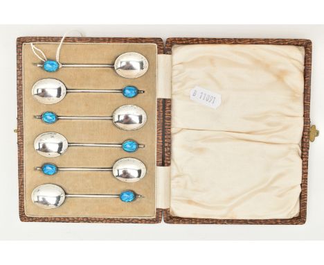 A CASED SET OF SIX EARLY 20TH CENTURY SILVER COFFEE SPOONS, each spoon set with a blue guilloche enamel cabochon to the handl