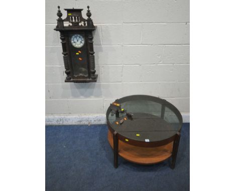 A MID CENTURY TEAK CIRCUALR TWO TIER COFFEE TABLE, with a smoked glass top, diameter 83cm x height 46cm, along with a wall cl