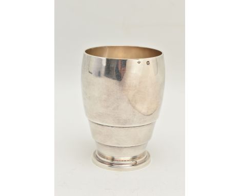 A WHITE METAL BEAKER, polished form on a circular base, stamped with French silver control marks, maker 'Louis Ravinet &amp; 