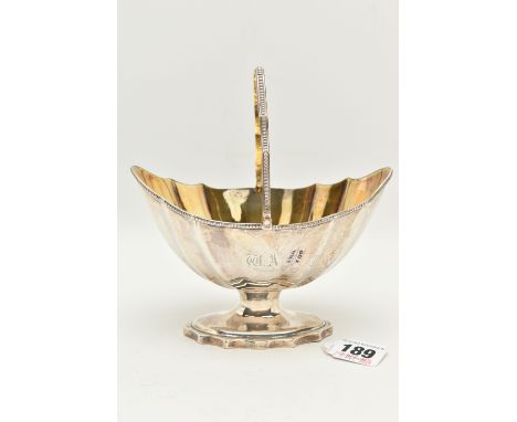 A GEORGE III SILVER SUGAR BASKET, polished design with engraved initials, raised on an oval wavy rim base fitted with a swing