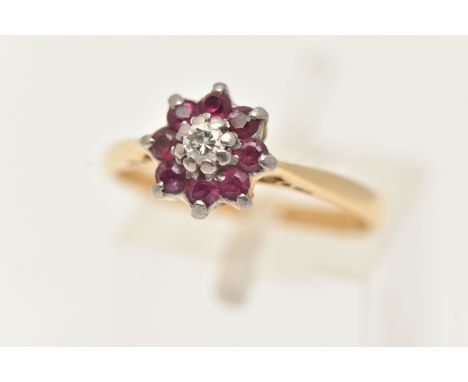 AN 18CT GOLD DIAMOND AND RUBY CLUSTER RING, a round brilliant cut diamond, prong set with a surround of eight circular cut ru