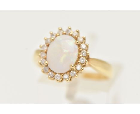 AN 18CT GOLD OPAL AND DIAMOND CLUSTER RING, an oval opal, prong set with a surround of round brilliant cut diamonds, leading 