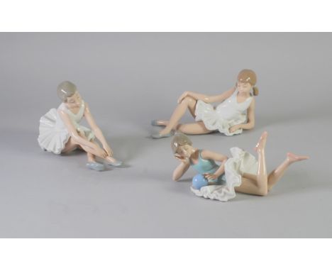 THREE NAO, SPANISH PORCELAIN FIGURES OF BALLERINAS, modelled seated or lying down, 9 1/2" (24.1cm) long and smaller, printed 