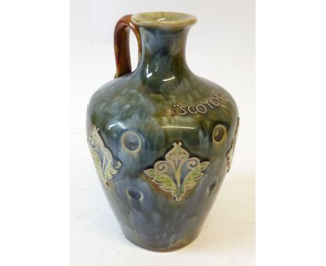 A LATE VICTORIAN DOULTON (LAMBETH) STONEWARE 'SCOTCH' WHISKEY JUG, with loop handle, the dimpled body with stylised leaf moti