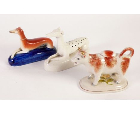 A VICTORIAN STAFFORDSHIRE POTTERY MODEL OF A RECUMBENT GREYHOUND on a blue glazed cushion base holed as a pin receiver, ANOTH