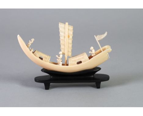 LATE NINETEENTH/EARLY TWENTIETH CENTURY CHINESE CARVED BOARS TUSK IVORY MODEL OF A CEREMONIAL BOAT, modelled with figures, sa