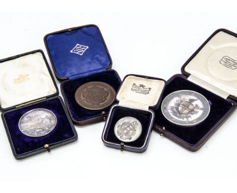 A George V 1934 silver medallion, for Lacey Doubles Fives Cup, engraved to back, together with two silver gilt and bronze med