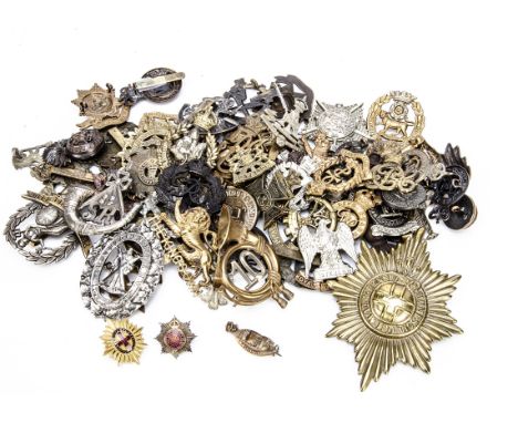 A collection of British cap badges, various ages, including a silver and enamel Royal Indian Army Service corps, Tenth London