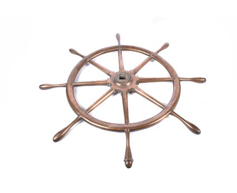 A solid bronze ship's wheel, the unmarked wheel with eight handles, of which one being set at a slightly different angle with