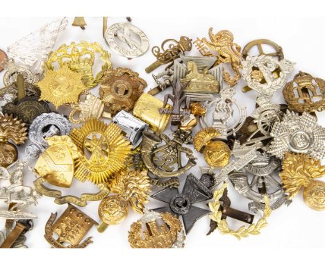 An assortment of British badges, including Royal Artillery Volunteers, 32nd Cornwall Light Infantry, AOC, 25th County of Lond