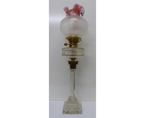 An oil lamp with glass Corinthian column base, total height 76cm, chips to base