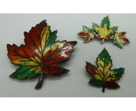 Three silver and enamel maple leaf brooches