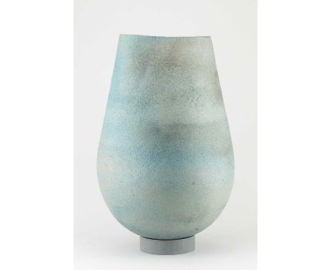 A large stoneware vessel with rounded base and textured surface covered in blue/grey and ochre glaze, height 40cm.Provenance: