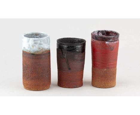 † ROBIN WELCH (1936-2019); a trio of small cylindrical stoneware vessels covered in different glazes, impressed RW marks, tal