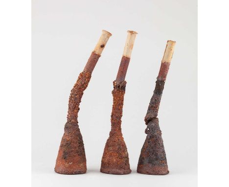 † ROBIN WELCH (1936-2019); a trio of leaning grogged stoneware bottles, impressed RW marks, tallest 34.5cm (3).Provenance: Es