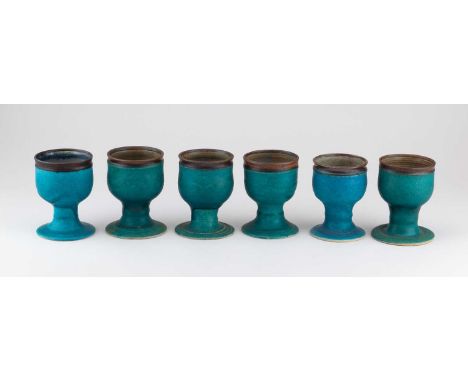 † ABDO NAGI (1941-2001); a set of six stoneware goblets covered in turquoise glaze with bronze rims, impressed marks, tallest