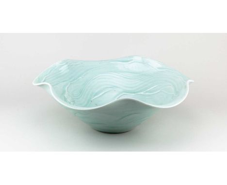 † JOANNA HOWELLS (born 1960); a large porcelain bowl with wavy rim covered in celadon glaze, impressed JH mark, diameter 35.5