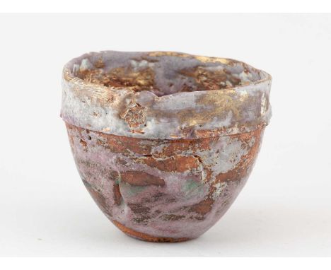 † ROBIN WELCH (1936-2019); a small stoneware bowl partially covered in lilac glaze with gold lustre rim, impressed RW mark, d