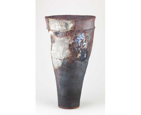 † ROBIN WELCH (1936-2019); a tall tapering stoneware vessel covered in bronze and grey glaze with patches of blue and black e