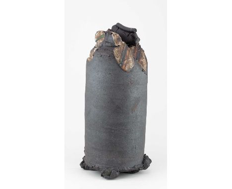 † DAN KELLY (born 1953); a tall cylindrical vessel raised on a cruciform foot covered in bronze glaze with torn and deconstru