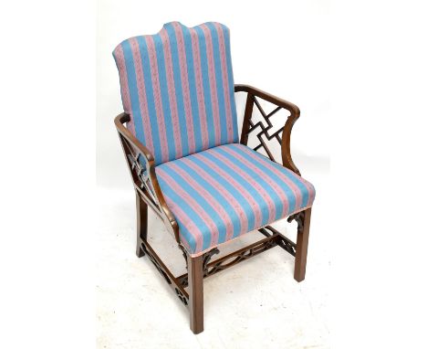 A 19th century mahogany Chippendale style elbow chair, upholstered in a modern striped material with pierced decoration to th