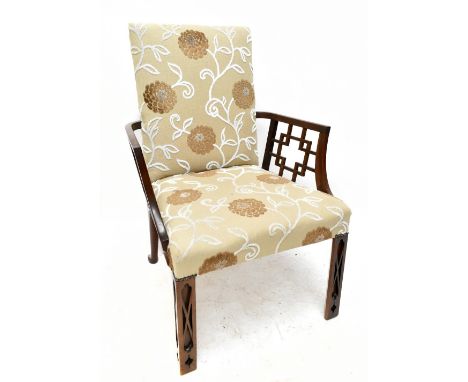 A 19th century mahogany Chippendale style elbow chair, with pierced decoration to the arms and blind fret decoration to the c