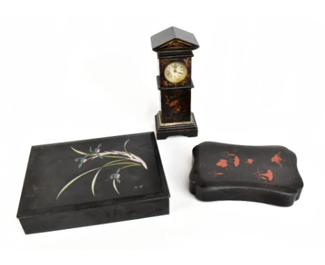 An late 19th century/early 20th century ebonised and lacquered miniature longcase clock, the circular dial set with Roman num