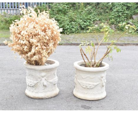 A pair of moulded composition conservatory or garden urns decorated with cherubs and floral swags, height 40cm, diameter 44cm
