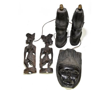 A pair of West African carved hardwood table lamps modelled as a male and female bust, height 46cm, together with a carved ha