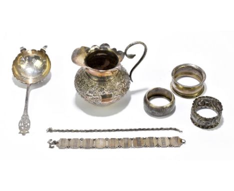 EUGENE LECLERE; an Elizabeth II hallmarked silver Coronation tea strainer, Sheffield 1953, together with three hallmarked sil