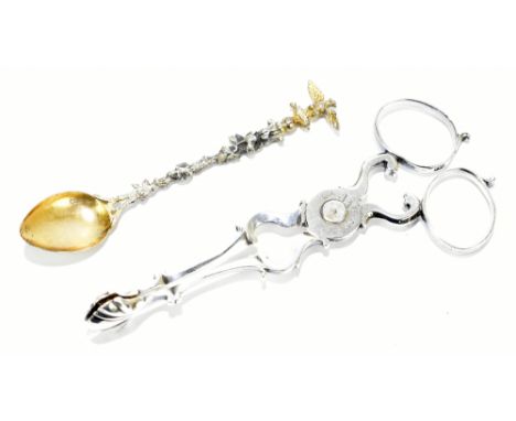 A pair of early 19th century silver sugar nips with shell shaped grippers, maker’s initials ‘I.G.’ and engraved initials ‘I.W