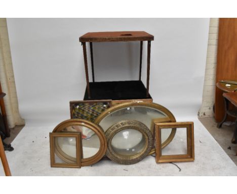 A large late 19th century gilt framed oval wall mirror with bevelled edge, width 94cm, together with a further oval wall mirr
