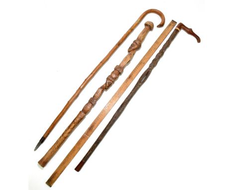 A carved softwood tribal walking stick decorated with two male masks, length 85.5cm, with an Austrian walking stick with spik