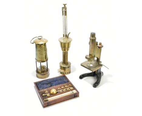 A small group of scientific instruments comprising a cased Sikes hydrometer, a further hydrometer-type brass instrument stamp