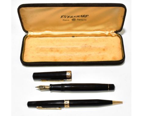 An Eversharp fountain pen and propelling pencil, each with a faceted black body, the fountain pen with a 14k nib, cased.Addit