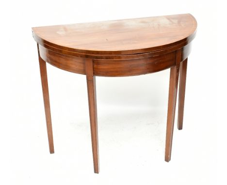 A Georgian mahogany demi-lune foldover card table raised on tapering block supports, width 91cm, height 76cm.