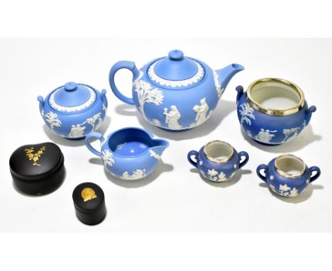 WEDGWOOD; a blue jasperware three piece tea service, decorated with maidens, together with two Wedgwood black basalt trinket 