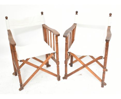 A pair of early 20th century ash and beech folding garden chairs with cloth backs and seats on turned legs, height 85cm.