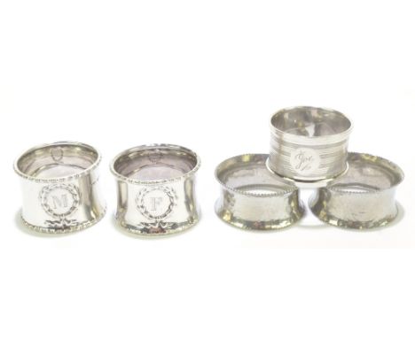 DOCKER &amp; BURN LTD; a pair of George V hallmarked silver napkin rings, with repoussé decoration of swags and bow, with eng