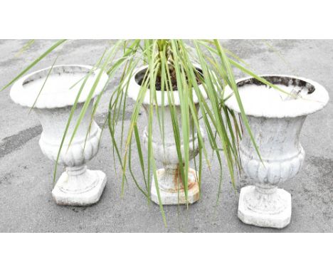 A cast iron garden jardiniere, 30cm high, with a cast iron plinth, 35cm high and a garden reconstituted stone planter on stan