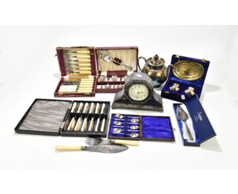 A group of silver plated items including cased flatware sets and fish servers, and a mantel clock.