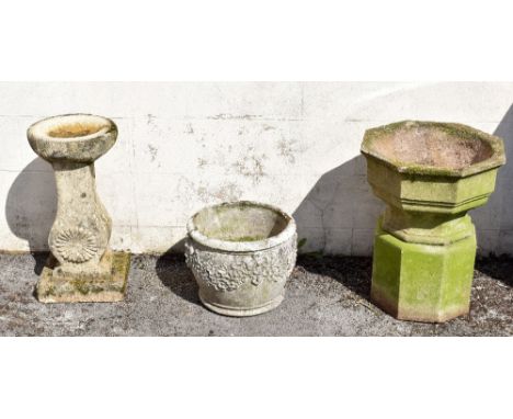 A reconstituted stone birdbath, the column moulded with a flower head, on square base, height 65cm, together with a reconstit