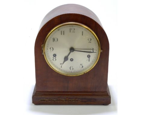 An Edwardian inlaid mahogany dome topped mantel clock, the silvered dial with Arabic numerals, raised on four bun feet, heigh